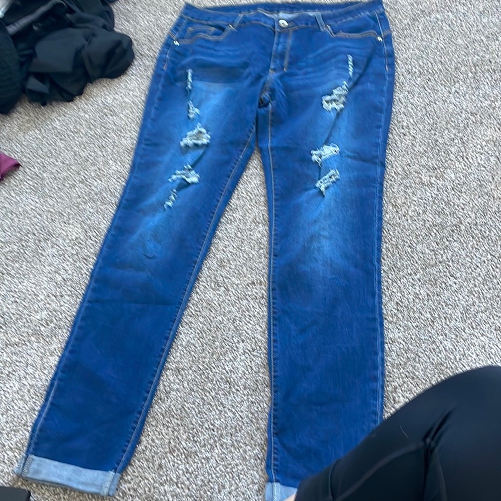 Light/bark blue jeans with holes  never warn